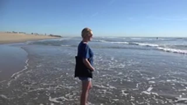 HUNTINGTON BEACH CALIFORNIA-2020: Woman Walking Towards The Ocean At The Beach