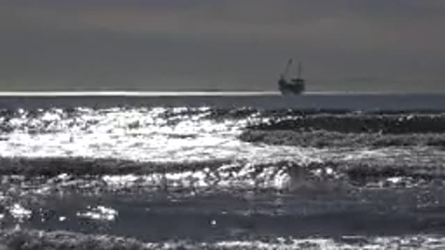 HUNTINGTON BEACH CALIFORNIA-2020: Tall Ship Moving Slowly on Sparkling Ocean