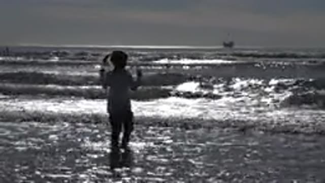 HUNTINGTON BEACH CALIFORNIA-2020: At Sunset A Little Girl Jumping In The Sand As