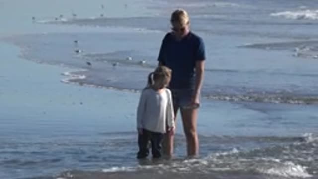 HUNTINGTON BEACH CALIFORNIA-2020: Mother And Daughter On The Beach Searching