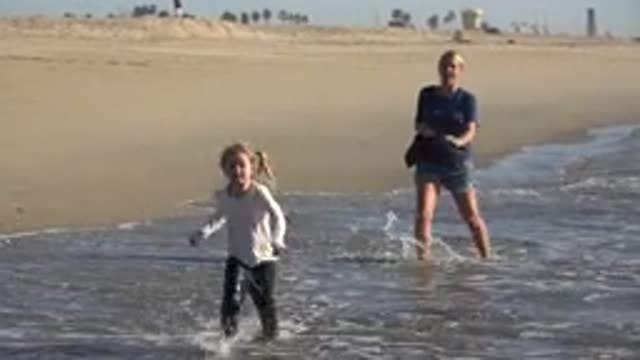 HUNTINGTON BEACH CALIFORNIA-2020: Mother And Daughter Go For A Walk On The Beach