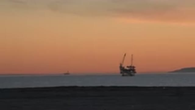 HUNTINGTON BEACH CALIFORNIA-2020: Evening Nightfall View Of The Sea With An Oil Extraction Plant