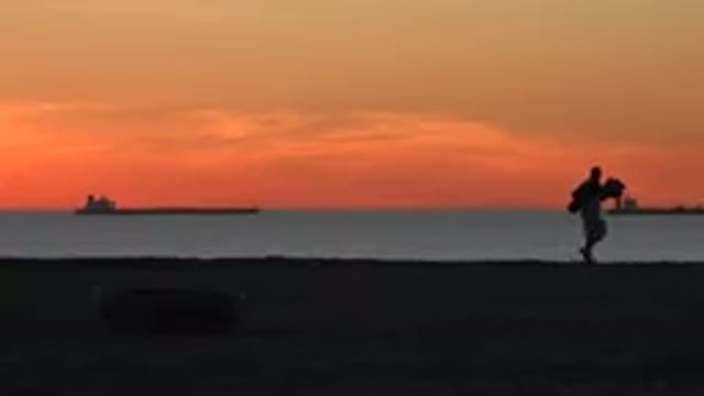 HUNTINGTON BEACH CALIFORNIA-2020: Pretty Orange Sky With Ships Near Horizon