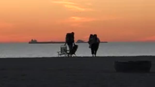 HUNTINGTON BEACH CALIFORNIA-2020: Amazing Footage Of Man And Woman Leaving The Beach At Sunset