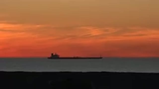 HUNTINGTON BEACH CALIFORNIA-2020: A Great Tanker Sails Placidly In The Sea At Sunset