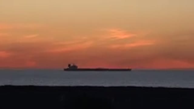HUNTINGTON BEACH CALIFORNIA-2020: Sunset With The Ocean Horizon View Of A Cargo Ship