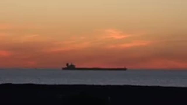 HUNTINGTON BEACH CALIFORNIA-2020: Pretty Orange Sky Tanker Ship In The Water In