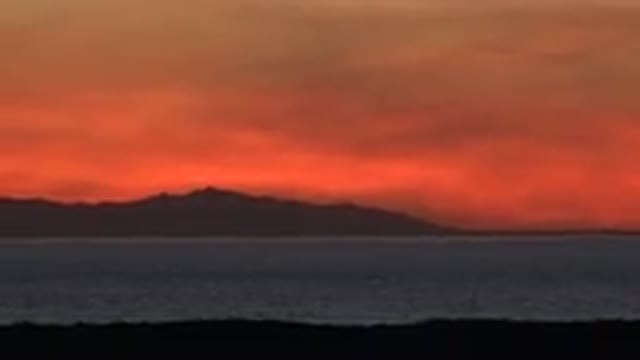 HUNTINGTON BEACH CALIFORNIA-2020: A Red Sky On The Horizon Over The Sea And