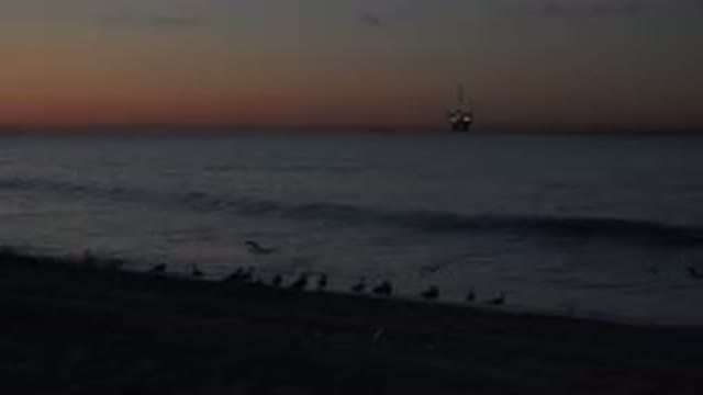 HUNTINGTON BEACH CALIFORNIA-2020: Sunset On A Beach With Small Waves And Seagulls