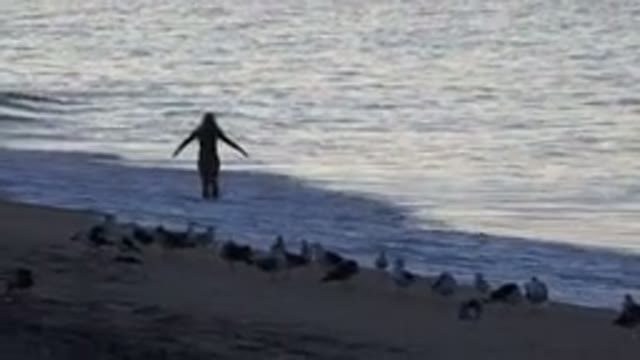 HUNTINGTON BEACH CALIFORNIA-2020: Woman Spinning Around On Sunset Beach
