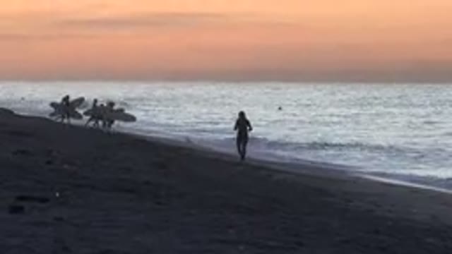 HUNTINGTON BEACH CALIFORNIA-2020: Sunset On The Beach Kids Jumping Into The Sea