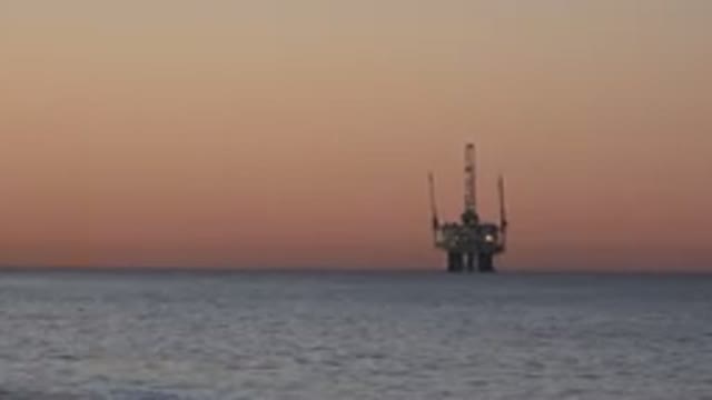 HUNTINGTON BEACH CALIFORNIA-2020: An Oil Rig On The Horizon Just Before The