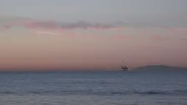 HUNTINGTON BEACH CALIFORNIA-2020: Oceanside View With An Oil Rig In The Far