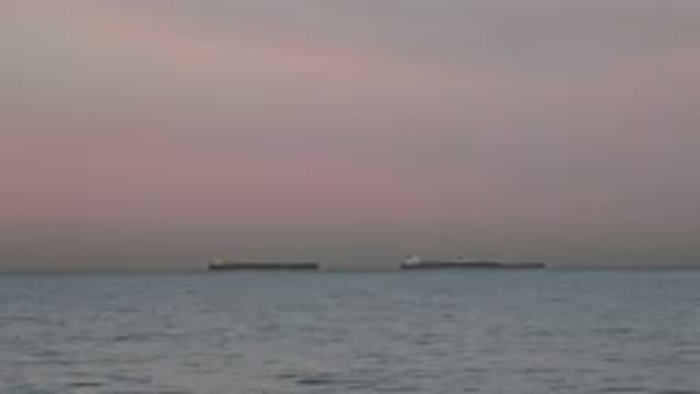 HUNTINGTON BEACH CALIFORNIA-2020: Pale Pink Sky Two Tanker Ships On Horizon Line