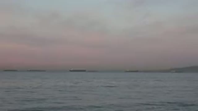 HUNTINGTON BEACH CALIFORNIA-2020: View Of Calm Blue Water And Rosy Sunset In Sky