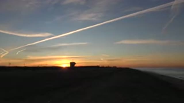 HUNTINGTON BEACH CALIFORNIA-2020: A Picturesque Sunset Over A Beach While Waves Roll