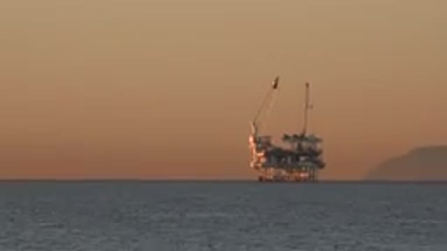 HUNTINGTON BEACH CALIFORNIA-2020: Video At Sunset Of An Oil Rig On The Ocean