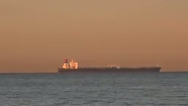 HUNTINGTON BEACH CALIFORNIA-2020: A Large Ship Floats In One Place On Calm Seas
