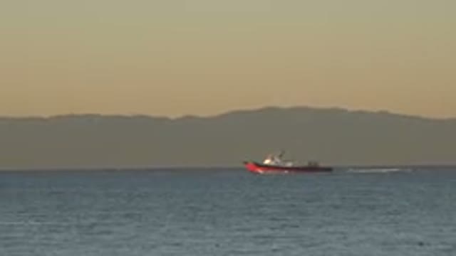 HUNTINGTON BEACH CALIFORNIA-2020: A Boat In The Immensity Of Water Of A