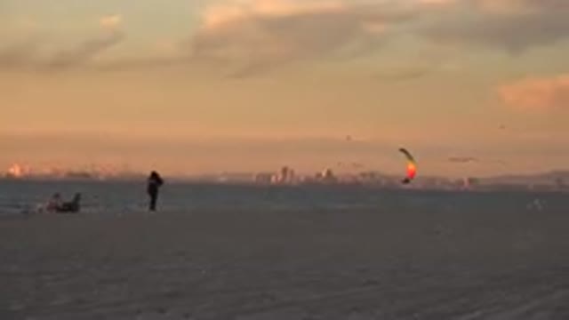 HUNTINGTON BEACH CALIFORNIA-2020: Person Flies Multicolored Kite On Beach On A