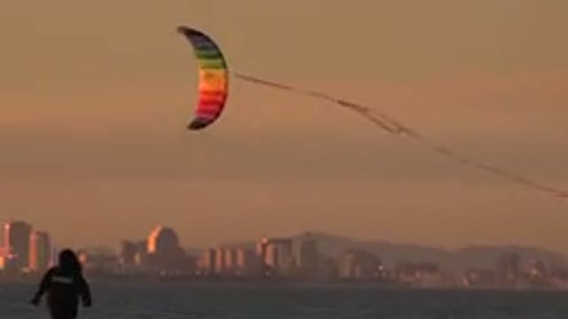 HUNTINGTON BEACH CALIFORNIA-2020: A Rainbow Kite Flying Above The Coast Near A
