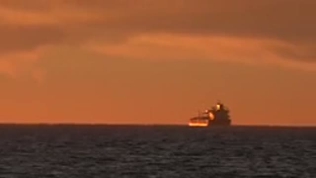 HUNTINGTON BEACH CALIFORNIA-2020: Large Vessel Floating In The Ocean During Sunset