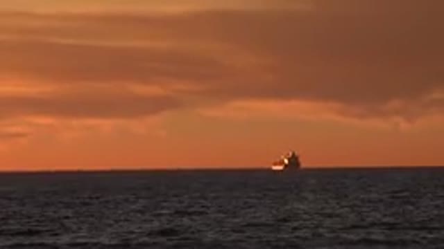 HUNTINGTON BEACH CALIFORNIA-2020: A Small Boa On The Immense Ocean Lonely In