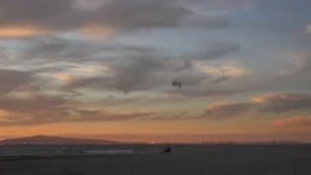 HUNTINGTON BEACH CALIFORNIA-2020: Someone Flies A Stunt Kite On The Beach At Sunset