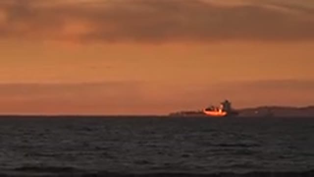 HUNTINGTON BEACH CALIFORNIA-2020: Tugboat Floating Distant In A Bay Of Water In