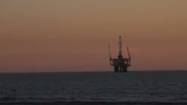 HUNTINGTON BEACH CALIFORNIA-2020: An Oil Platform In The Sea Seen From The Beach