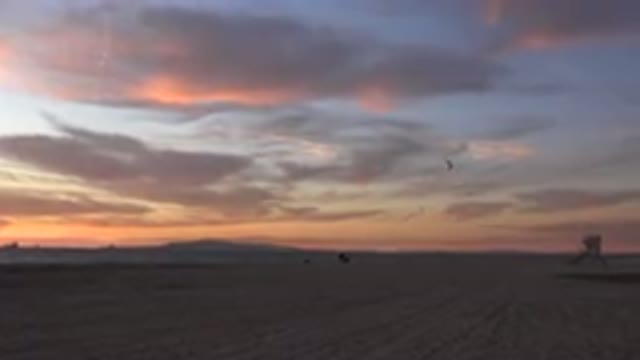 HUNTINGTON BEACH CALIFORNIA-2020: Person Flying a Kite at Sunset on the Beach