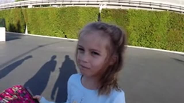 DISNEYLAND CALIFORNIA-2020: Girl Wearing White Shirt Holds Black And Purple Fan