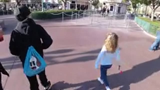 DISNEYLAND CALIFORNIA-2020: Two Children Walking Around A Park While Being