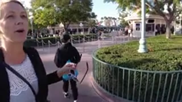 DISNEYLAND CALIFORNIA-2020: Woman Wearing Black Sweater Points At Object With