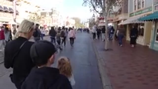 DISNEYLAND CALIFORNIA-2020: Mother With Her Two Children Walking On A Busy