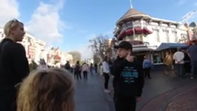 DISNEYLAND CALIFORNIA-2020: Woman Wearing Black Shirt Points At Off Screen