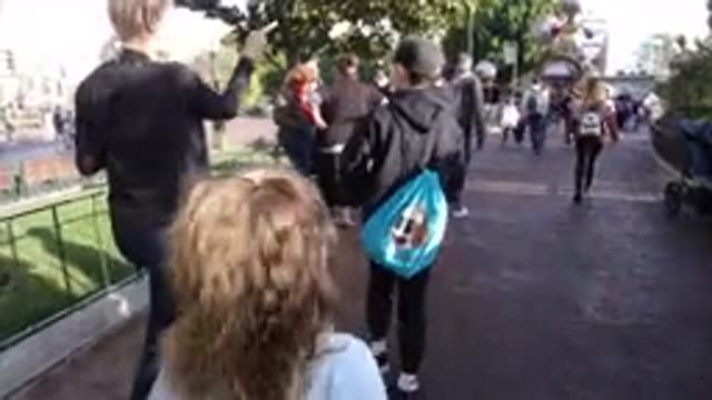 DISNEYLAND CALIFORNIA-2020: Woman Wearing Black Pants And Sweater Walks With