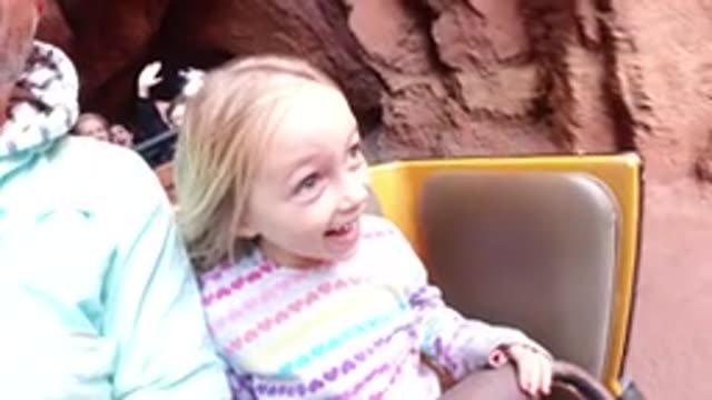 DISNEYLAND CALIFORNIA-2020: Little Girl Riding Amusement Park Ride Through Rocks