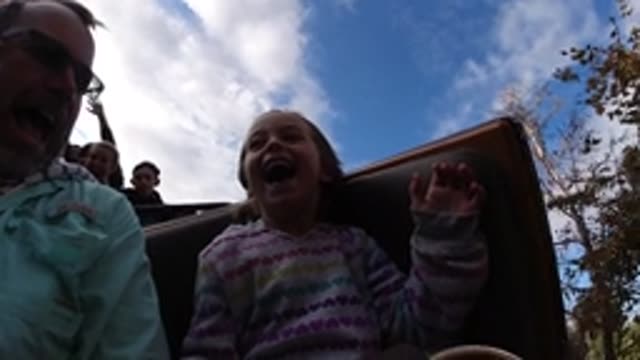 DISNEYLAND CALIFORNIA-2020: Kid With Her Father Having Fun At A Ride On An