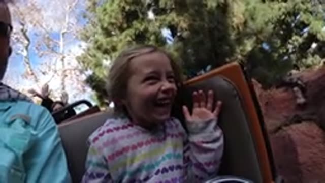 DISNEYLAND CALIFORNIA-2020: A Little Girl Is Playing In A Theme Park With Her Parents