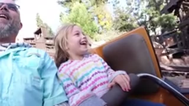 DISNEYLAND CALIFORNIA-2020: Girl Riding Grandfather