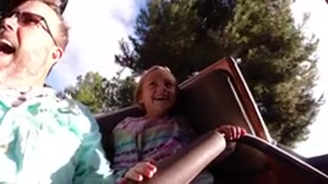 DISNEYLAND CALIFORNIA-2020: A Young Girl And Her Father Ride A Children's Roller Coaster