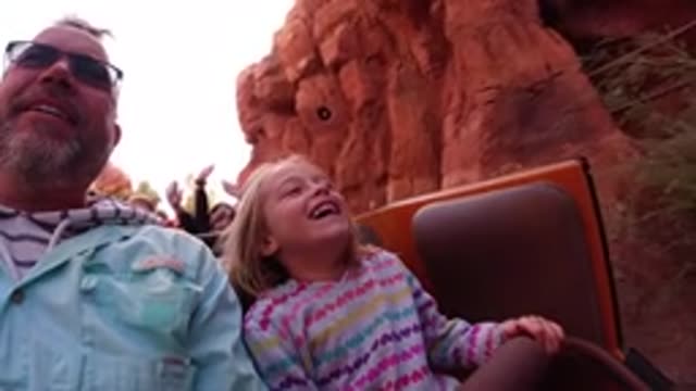 DISNEYLAND CALIFORNIA-2020: Man And Young Girl Smile And Laugh As They Ride