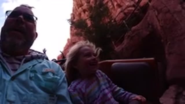 DISNEYLAND CALIFORNIA-2020: Little Girl With Male Family Member Riding On An Attraction