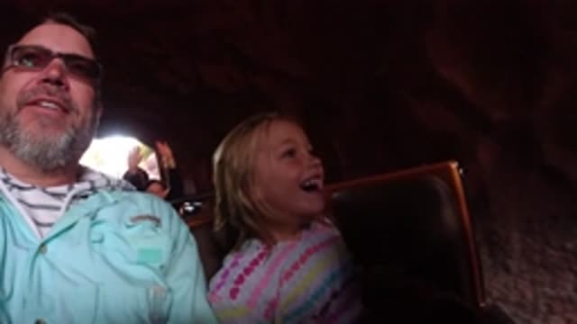 DISNEYLAND CALIFORNIA-2020: Dad Brings His Excited And Smiling Daughter On A Roller Coaster Ride