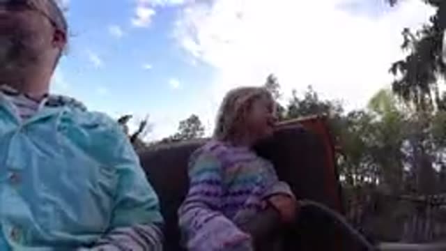 DISNEYLAND CALIFORNIA-2020: Girl Wearing White Striped Jacket Looks At Passing Objects