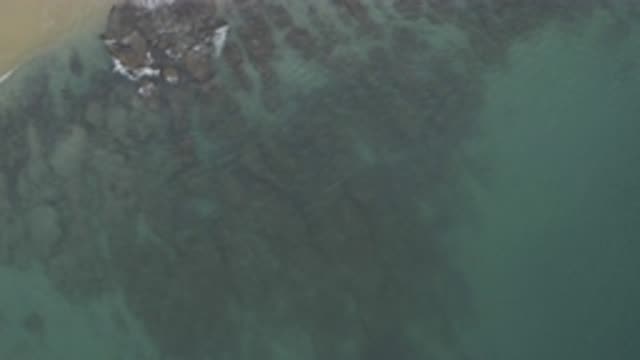 EAST CAPE BCS MEXICO-2019: View Of Grey Rocks, Tan Beach And Blue Ocean Water