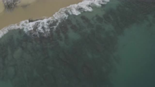 EAST CAPE BCS MEXICO-2019: An Aerial View Of Waves Of Light Blue Water Arriving