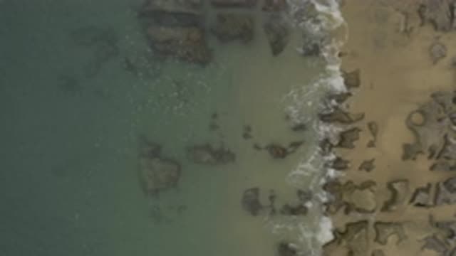 EAST CAPE BCS MEXICO-2019: View Of Grey Rocks Under Blue-Green Ocean Water On A