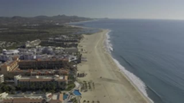 EAST CAPE BCS MEXICO-2019: Slow-Flying Drone Shot of Beachfront with Hang Glider